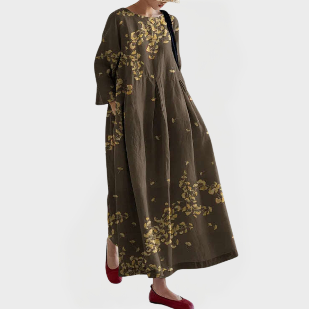 Elegantna maksi haljina iz lana z izšivanim cvetličnim vzorcem.