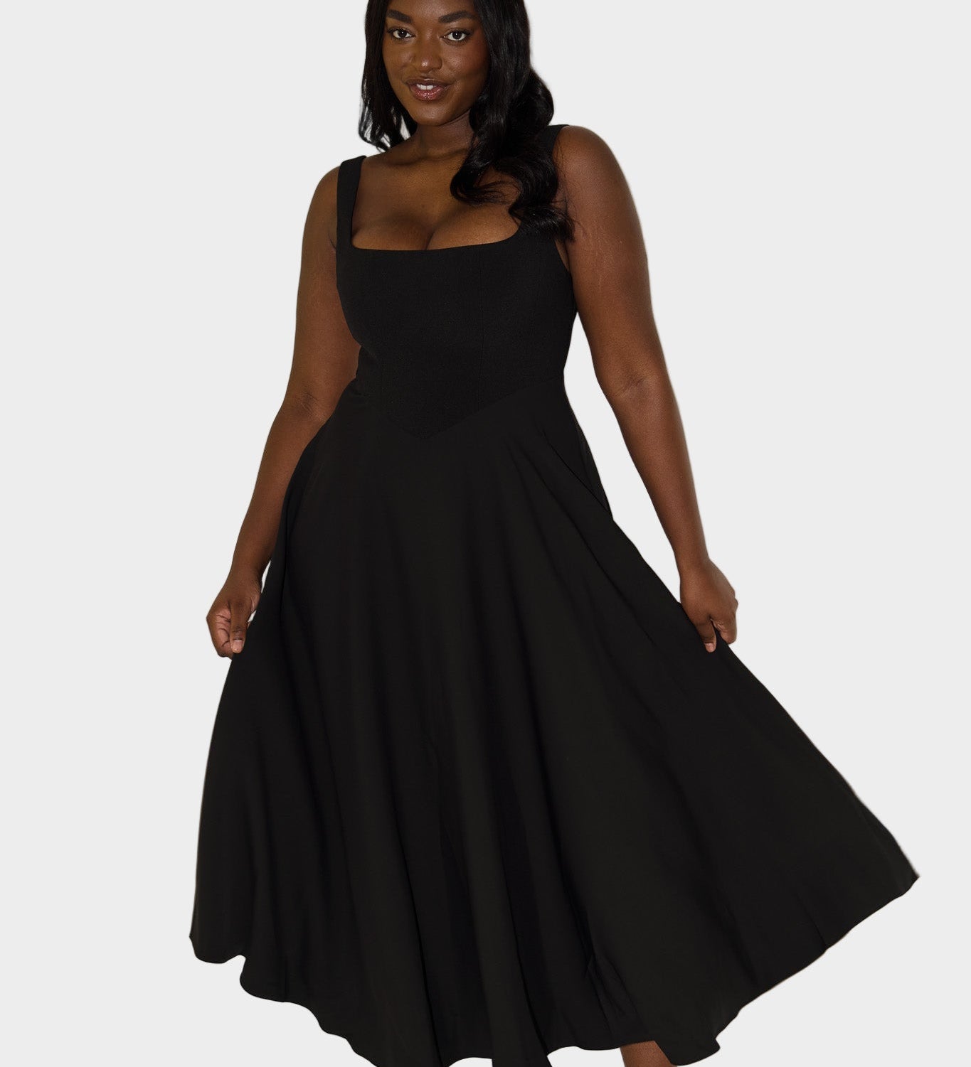 Klasična, lahka midi obleka z elegantnim krojem in naravnim gibom.